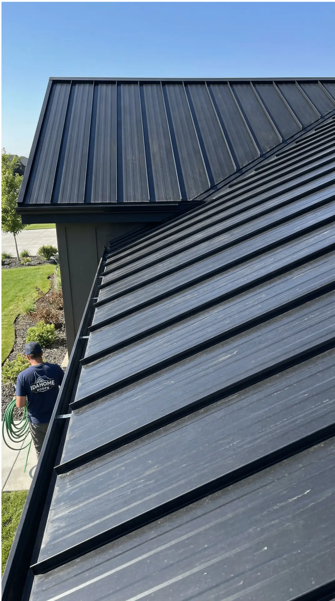 Close view of black standing-seam metal roofing during installation