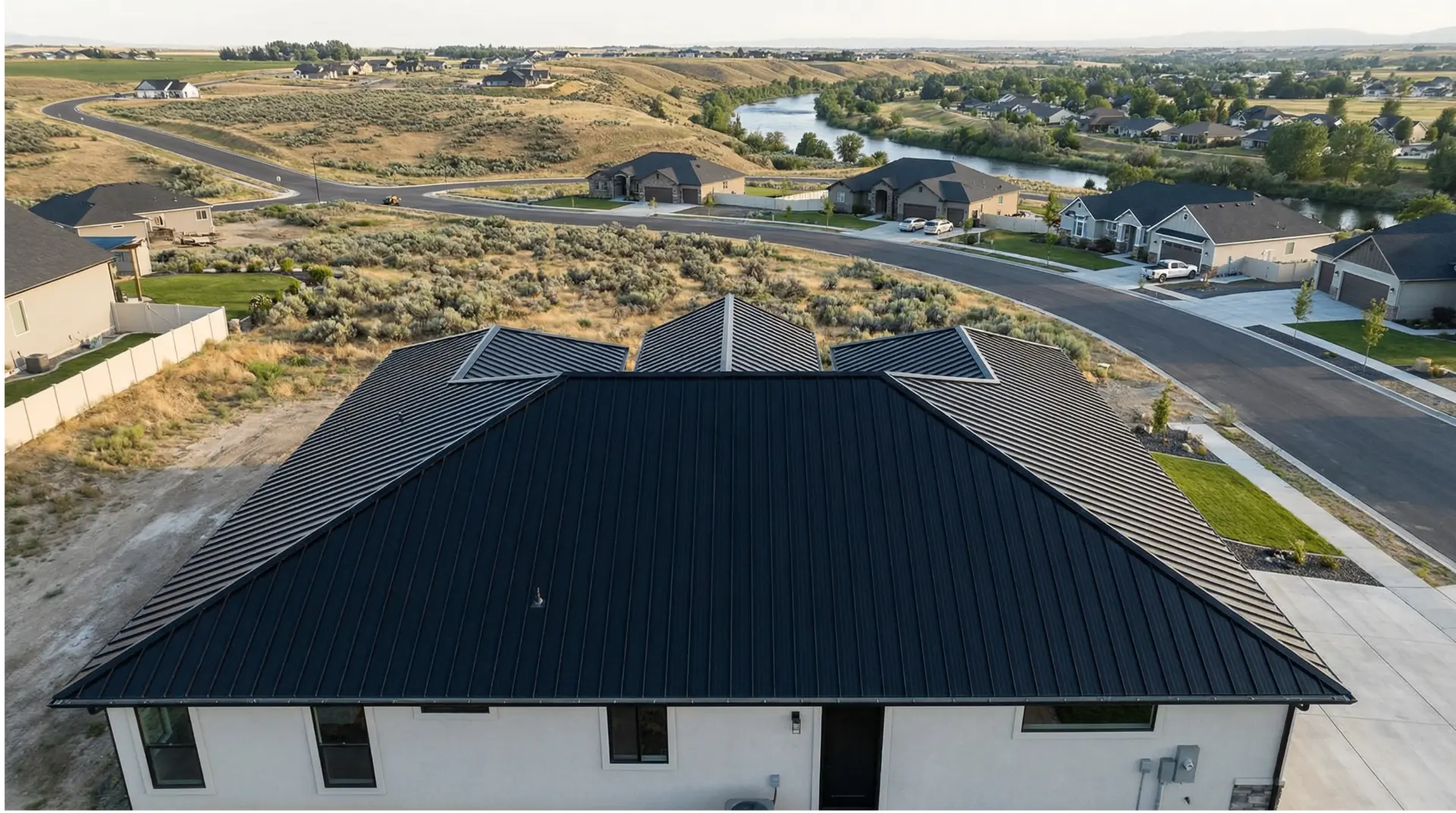 Aerial view of a completed black metal roof in an Idaho neighborhood