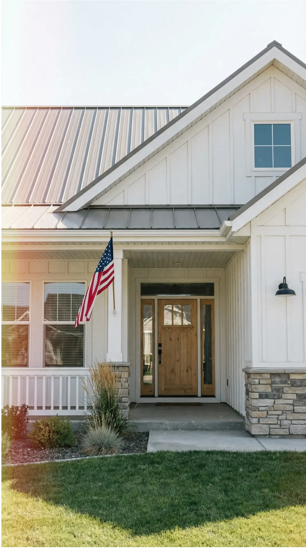 White Idaho farmhouse with board-and-batten siding and a metal roof